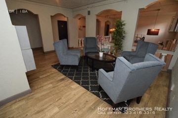 Los Angeles apartment for rent - a living room with three chairs and a table