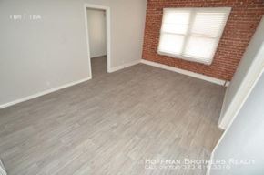 Los Angeles apartment for rent - an empty room with a brick wall and wood floors