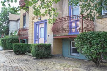 Pittsburgh apartment for rent - A building with a blue door and a red balcony.
