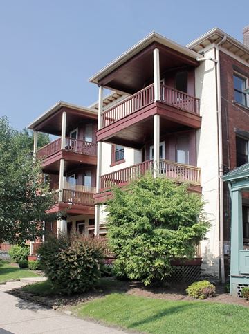 Pittsburgh apartment for rent - A building with a red brick facade and a balcony.