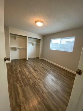 San Diego apartment for rent - A room with a window and a wooden floor.