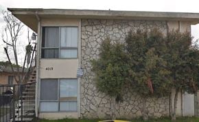 San Diego apartment for rent - a stone building with a tree in front of it