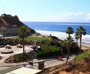 Solana Beach apartment for rent - a view of the beach and the ocean from a park with palm trees