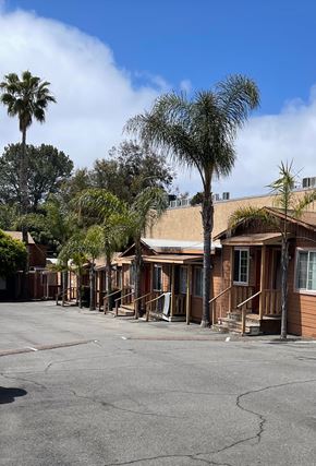 Solana Beach apartment for rent - a row of small buildings with palm trees