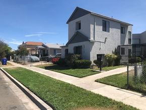 San Diego apartment for rent - a white house with a yard and a sidewalk