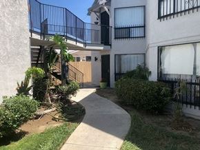 San Diego apartment for rent - an outside view of a building with a walkway and a balcony