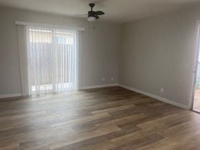San Diego apartment for rent - an empty living room with wood floors and a ceiling fan
