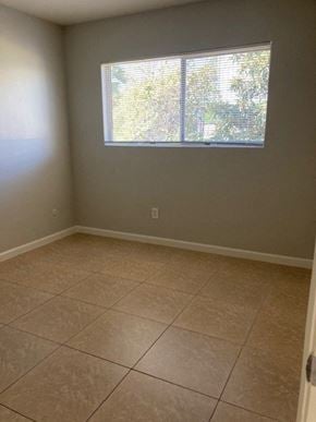 San Diego apartment for rent - an empty room with a window and tiled floors