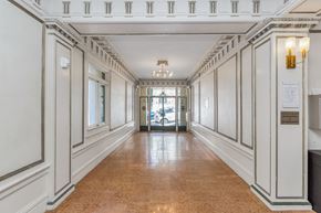 San Francisco apartment for rent - A long hallway with white walls and a brown floor.