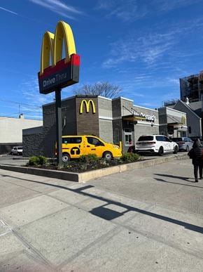 Astoria apartment for rent - A McDonald's drive thru with a yellow car in front.