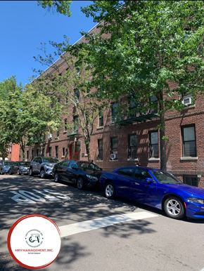 Astoria apartment for rent - A blue car is parked on the side of a street.