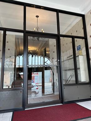 Astoria apartment for rent - A glass door with a red mat in front of it.