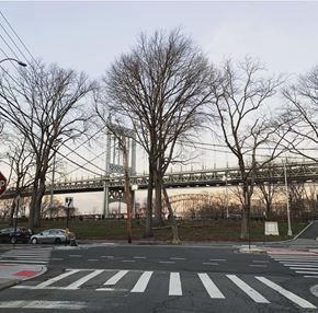 Astoria apartment for rent - a city street with a suspension bridge in the background