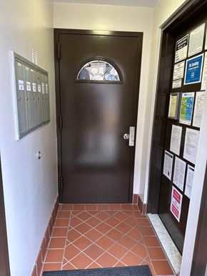 Astoria apartment for rent - the front door of a building with a tiled floor