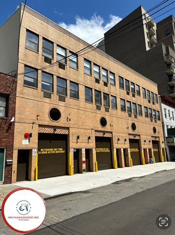 Astoria apartment for rent - a brick building on a city street with a red circle