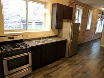 Chicago apartment for rent - A kitchen with a stove, sink, and refrigerator.