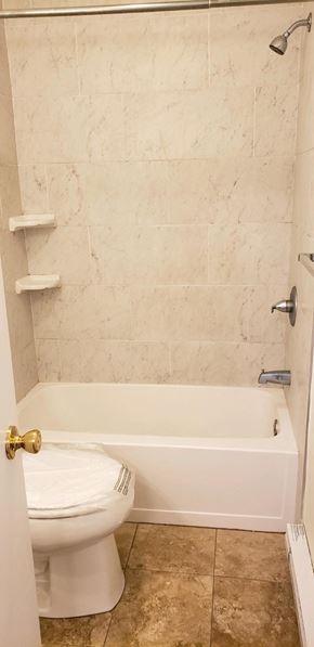 Milford apartment for rent - a bathroom with a toilet and a bath tub