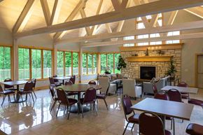 Comstock Park apartment for rent - a large dining room with tables and chairs and a fireplace