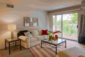 Comstock Park apartment for rent - a living room with a couch and a table   and a balcony