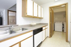 Comstock Park apartment for rent - a kitchen with a sink and a door to a laundry room