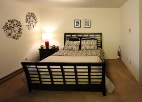 Spokane apartment for rent - a bedroom with a bed and a nightstand and a window