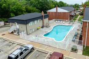 Fraser apartment for rent - A swimming pool is surrounded by a fence in a parking lot.