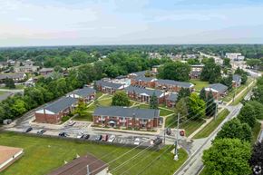 Fraser apartment for rent - A large building complex with a parking lot in front.