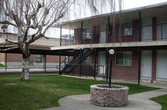 Spokane apartment for rent - an apartment building with a courtyard and a tree