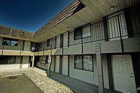 Spokane apartment for rent - an apartment building with white doors and windows and a courtyard