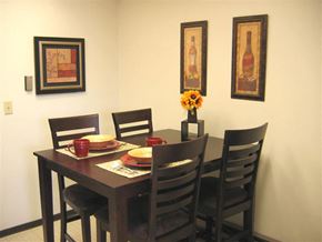Spokane apartment for rent - a dining room table with chairs and plates on it