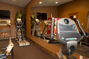 Spokane Valley apartment for rent - A gym with a treadmill, elliptical trainer and a stationary bike.