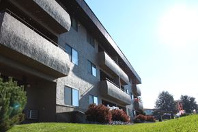 Spokane Valley apartment for rent - A modern building with a grassy area in front.