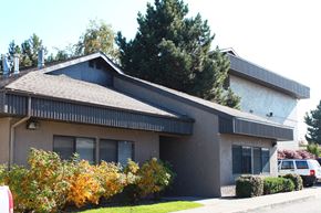 Spokane Valley apartment for rent - A house with a grey roof and a white car parked in front.