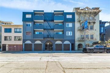 San Francisco apartment for rent - A blue building with a black car parked in front.