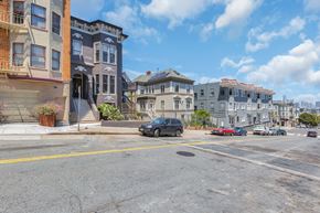 San Francisco apartment for rent - A street view with buildings on the side and cars parked on the side of the road.