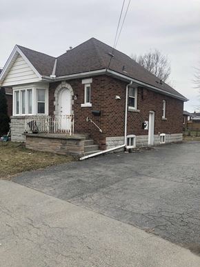 Hamilton apartment for rent - the front of a brick house with a porch and stairs