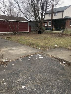 Hamilton apartment for rent - a sidewalk in front of a house with trash on it