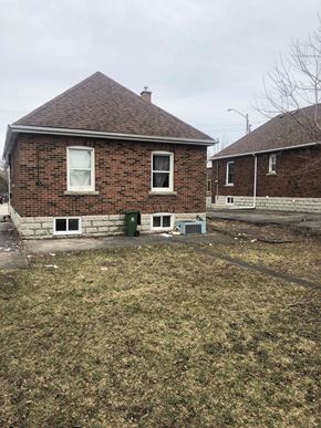 Hamilton apartment for rent - a brick house with a yard in front of it