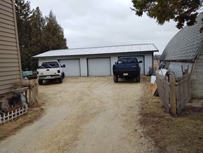 Port Washington apartment for rent - a garage with two trucks parked in front of it