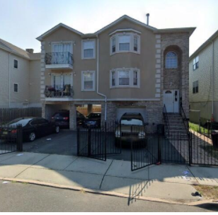 Newark apartment for rent - A two-story house with a balcony on the second floor.