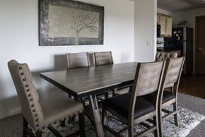 Grand Rapids apartment for rent - a dining room table with chairs and a painting on the wall