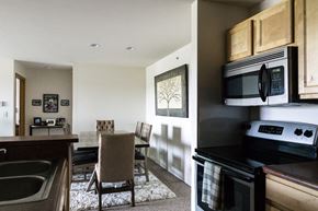 Grand Rapids apartment for rent - a kitchen and dining room with a table and chairs and a microwave and a stove