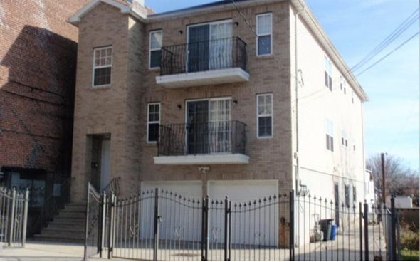 Newark apartment for rent - A large two-story building with a balcony on the second floor.