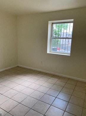 Newark apartment for rent - A room with a window and tiled floor.