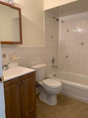 Newark apartment for rent - A white toilet sits next to a bathtub in a bathroom.