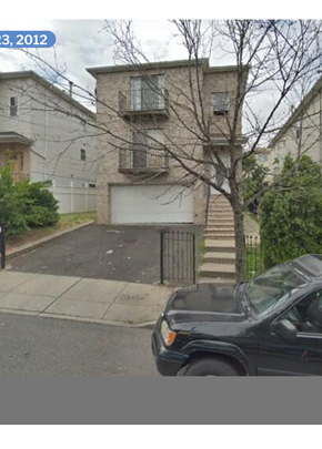 Newark apartment for rent - A black car is parked in front of a house.