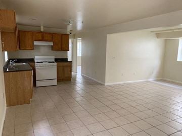 Newark apartment for rent - A kitchen with white appliances and wooden cabinets.