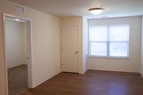 Chicago apartment for rent - an empty living room with a door and a window