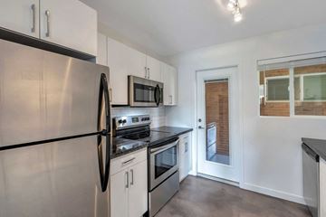 Phoenix apartment for rent - a kitchen with stainless steel appliances and white cabinets