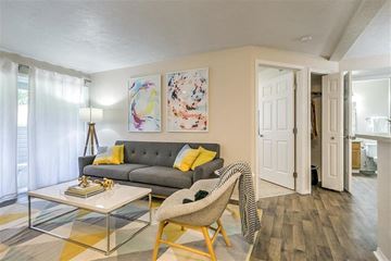 Boise apartment for rent - A living room with a grey couch and a glass coffee table.